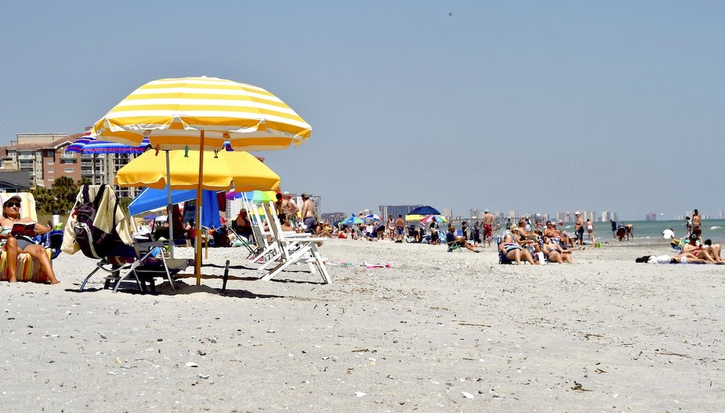 The high tide is encroaching on Marsha Hamlin, 58, and her daughter Courtney Hamlin, 23, who are vacationing from Indiana on Belleair Beach. (JIM DAMASKE | Times)